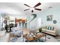 Open-concept living area with modern decor, including an elegant ceiling fan and stylish furniture at 356 Giovani Blvd, Clermont, FL 34715