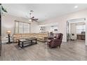Spacious living room with modern flooring, neutral paint, ceiling fan and an open floorplan at 3733 Statham Dr, Apopka, FL 32712