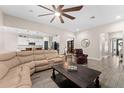 Open-concept living area with wood-look tile, neutral walls, and a view into the kitchen at 3733 Statham Dr, Apopka, FL 32712