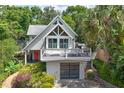 An appealing exterior featuring an elevated deck, modern garage door, and well-maintained landscaping at 421 W 10Th Ave, Mount Dora, FL 32757