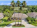 Aerial view of home with expansive back yard and views of a lake and nature preserve at 4547 Inverness Dr, Leesburg, FL 34748