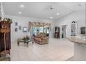 Spacious living room with vaulted ceilings, tile floors, and large sliding glass doors to the lanai at 4547 Inverness Dr, Leesburg, FL 34748