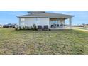 View of backyard with sliding glass doors to covered patio at 5463 Nickerbean St, Apopka, FL 32712