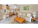 Cozy living room and dining area, featuring a comfortable sofa and a view into the dining area at 741 Royal Palm Ave, Lady Lake, FL 32159
