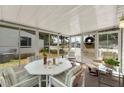Bright sunroom with comfortable seating, a game table and screened windows, offering an airy space at 741 Royal Palm Ave, Lady Lake, FL 32159
