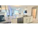 Bright kitchen featuring stainless steel appliances, stone countertops, and an open view to the dining area at 817 Ocean Course Ave # 502, Davenport, FL 33896