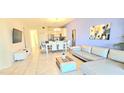 Spacious living room with modern décor including tile floors, dining table, and comfortable couch at 817 Ocean Course Ave # 502, Davenport, FL 33896