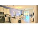 Open-concept living space with modern kitchen, dining area, and comfortable seating at 817 Ocean Course Ave # 502, Davenport, FL 33896
