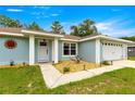 Inviting entrance with decorative details, pathway, and a well-manicured lawn at 8869 Se 159Th Pl, Summerfield, FL 34491