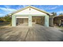 Detached two car garage with automatic door openers and additional storage shed to the side of the garage at 9236 County Road 48, Yalaha, FL 34797