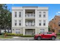 Exterior view of a condominium building with a red car, and balconies at 1021 Siena Park Blvd # 204, Kissimmee, FL 34747