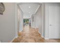 Bright foyer with tiled floors, arched doorways, white trim, and a view into the living area at 1027 Timbervale Trl, Clermont, FL 34715