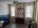 Inviting living room with cozy seating, decorative accents, and natural light from windows with curtains at 1033 N Jacks Lake Rd, Clermont, FL 34711
