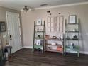 Bright room with wood-look floors, decorative ladder shelves, and inviting front door at 1033 N Jacks Lake Rd, Clermont, FL 34711