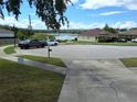 Scenic neighborhood street view, showcasing landscaping and a glimpse of a lake in the distance at 1033 N Jacks Lake Rd, Clermont, FL 34711