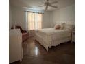 Bright bedroom with a queen-sized bed, dresser, and decorative chair at 1060 Davenport Dr, The Villages, FL 32162