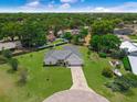 Beautiful single-story home boasting a lush green lawn and mature trees in a serene, park-like setting at 111 Ridgeview Cir, Eustis, FL 32726