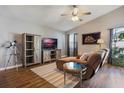 Cozy living area featuring a chaise lounge, wood floors, and stylish decor accents at 12430 Ne 52Nd Loop, Oxford, FL 34484