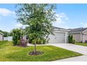 Exterior shot of a single Gathering home, well manicured, blue skies and healthy lawn at 1247 Mezzavalle Way, Auburndale, FL 33823