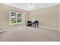 Bright bedroom featuring neutral carpet and large windows, providing ample natural light and a serene atmosphere at 12512 Lake Ridge Cir, Clermont, FL 34711