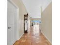 Spacious hallway with terracotta tile flooring, leading to an open living area with scenic views at 12512 Lake Ridge Cir, Clermont, FL 34711