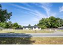 Street view of single-story home featuring a fenced yard and freshly painted exterior at 14350 Se 36Th Ave, Summerfield, FL 34491