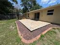 Spacious backyard featuring a brick-paver patio outlined with decorative stones at 14466 Se 45Th Ct, Summerfield, FL 34491