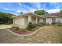 A welcoming two-car garage residence with well-maintained landscaping, and a charming front walkway at 14490 Se 96Th Ter, Summerfield, FL 34491