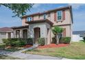 Beautiful home showcasing its front elevation, lush lawn, and welcoming entrance way at 14832 Royal Poinciana Dr, Orlando, FL 32828