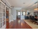 Open-concept living area with hardwood floors, stylish furnishings, and modern decor at 14832 Royal Poinciana Dr, Orlando, FL 32828