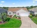 An aerial view showing the home, driveway, and manicured front yard landscaping at 17916 Se 87Th Melrose Ct, The Villages, FL 32162