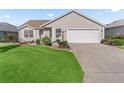Beautiful single-story home boasts a tidy lawn and landscaped front yard at 17916 Se 87Th Melrose Ct, The Villages, FL 32162
