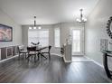 Bright dining room with modern lighting and a view of the front entrance at 1914 Armondo Dr, The Villages, FL 32159
