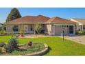 Charming single-story home with a manicured lawn and inviting curb appeal at 1914 Armondo Dr, The Villages, FL 32159