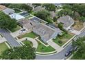 Aerial view of home featuring a circular driveway, manicured lawn, mature trees, and a well-maintained neighborhood at 19624 Spring Oak Dr, Eustis, FL 32736