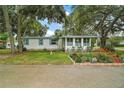 Cozy single-story home with a well-maintained lawn and colorful flowerbeds, offering a welcoming curb appeal at 2110 Oak Cir, Mount Dora, FL 32757