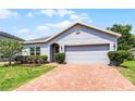 Beautiful one story home with manicured lawn, mature landscaping and brick driveway at 23707 Companero Dr, Sorrento, FL 32776