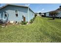Expansive backyard with lush green grass and trees at 24841 Pine Hl, Leesburg, FL 34748