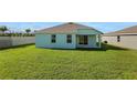 Large grassy backyard featuring a covered patio and well-maintained lawn at 2860 Supermarine Rd, Tavares, FL 32778