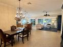 Open-concept living and dining areas with neutral tile flooring and lots of natural light at 2918 Canyon Ave, The Villages, FL 32163