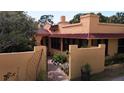 Charming home featuring a stucco exterior, a red tile roof, and a gated entrance with a brick walkway at 308 Sunnyside Dr, Leesburg, FL 34748