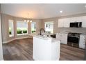 Eat-in kitchen features white cabinets, granite countertops, stainless steel appliances and a breakfast bar at 3177 Williams Rd, The Villages, FL 32162