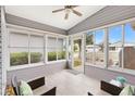 Sunroom with tiled floors, ceiling fan, and large windows offering views of the outdoors at 3472 Roanoke St, The Villages, FL 32162