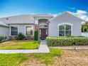Close-up of the home's front door with stone facade and manicured bushes at 3731 Peaceful Valley Dr, Clermont, FL 34711