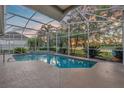 Screened-in pool featuring a waterfall feature and view of the surrounding landscape at 4879 Brightmour Cir, Orlando, FL 32837