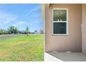 View of the spacious back yard from the home's exterior at 4998 Abigail Dr, Lake Wales, FL 33859