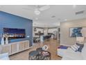 Open-concept living room flowing into a kitchen with stylish blue accent wall and modern decor at 524 Silver Palm Dr, Haines City, FL 33844