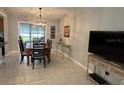 Inviting dining area featuring a chandelier, table with four chairs, and lots of natural light at 529 Del Mar Dr, Lady Lake, FL 32159