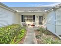 Cozy front porch seating area with charming decor and manicured landscaping at 529 Del Mar Dr, Lady Lake, FL 32159