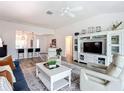 Bright and spacious living room with modern furnishings, neutral colors, and wood flooring at 6633 Holovak Ter, The Villages, FL 34762